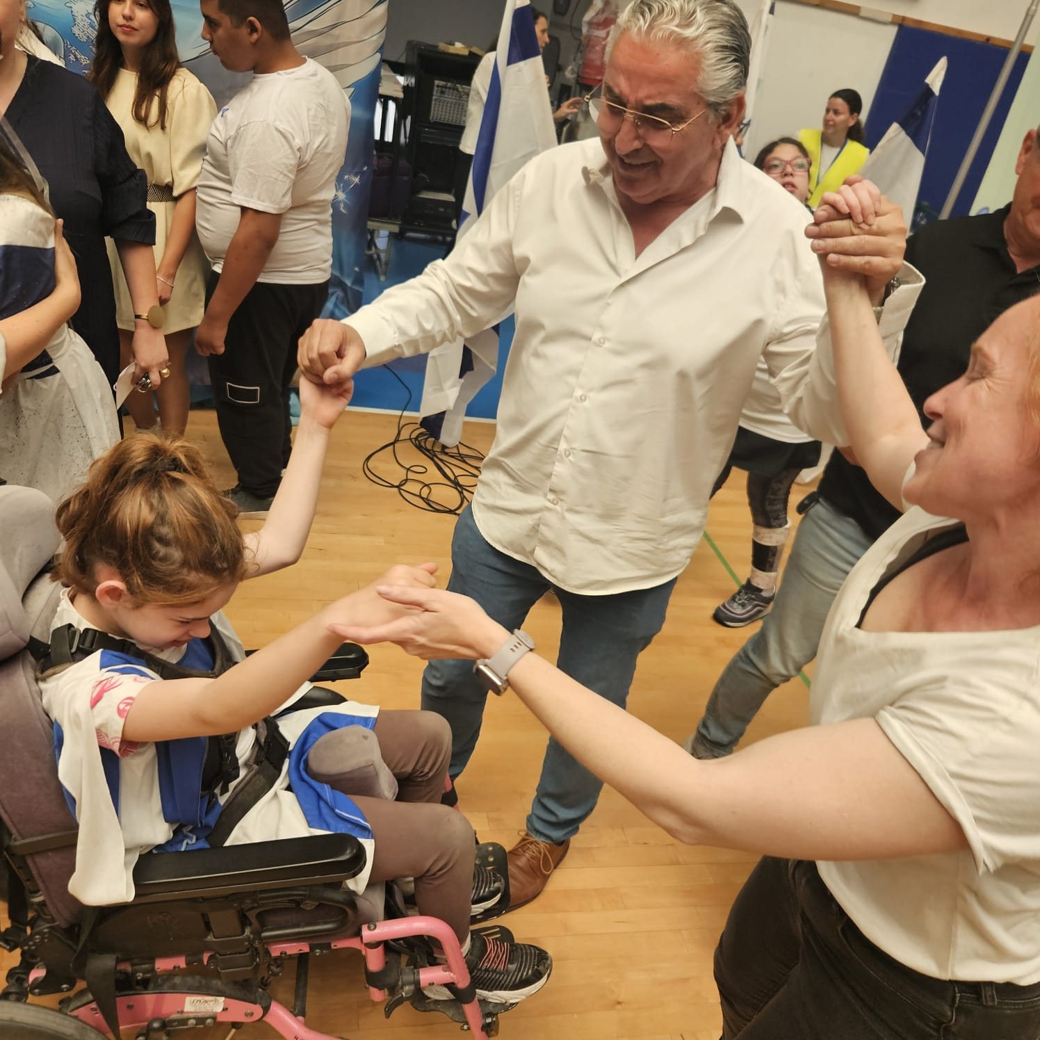 Mayor of Raanana, Mr. Chaim Broide, dancing hand in hand with the students